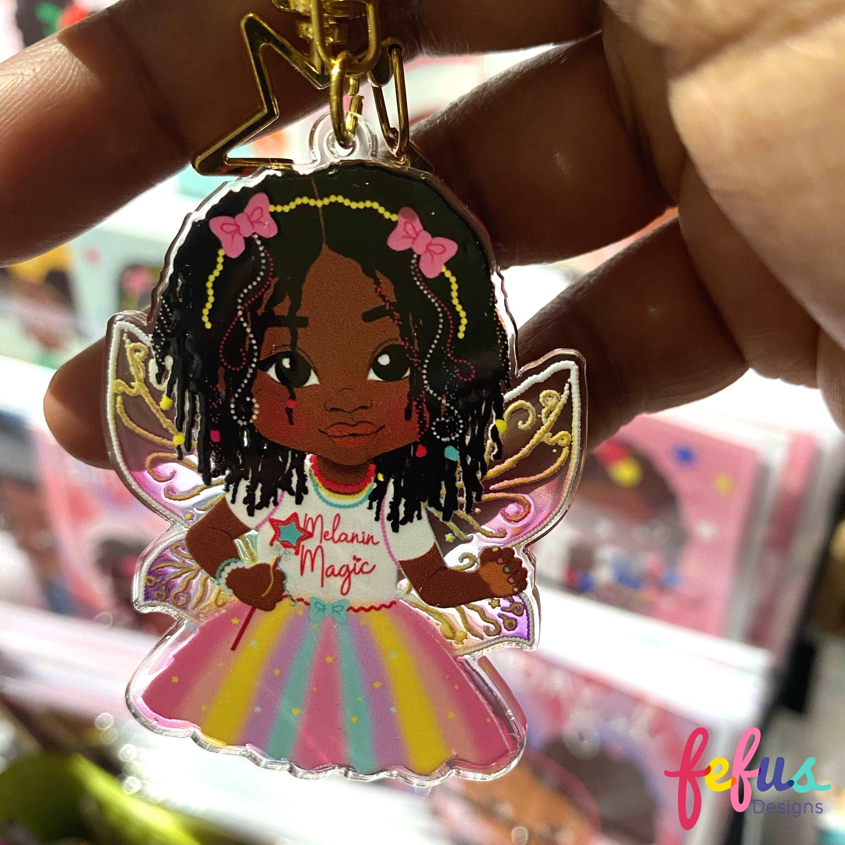 Ariyonna Rasta Fairy Magic keyring featuring a character with long locs and iridescent wings by Fefus Designs. Empowering Kids with Joyful Diversity! Perfect Bag Charm Gift | Fefus Designs