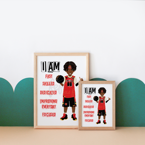 Two framed basketball-themed motivational posters displayed on a beige surface against a white wall with teal scalloped wall decals. The larger poster shows a cartoon basketball player in a red jersey holding a ball, with text reading 'I AM FAST SKILLED DEDICATED IMPROVING EVERYDAY FOCUSED.