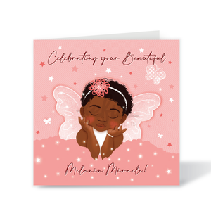 A square pink greeting card featuring an illustrated Black child with angel wings, a floral headband, and the text 'Celebrating your Beautiful' and 'Melanin Miracle!'. The card is shown standing against a clean white background.