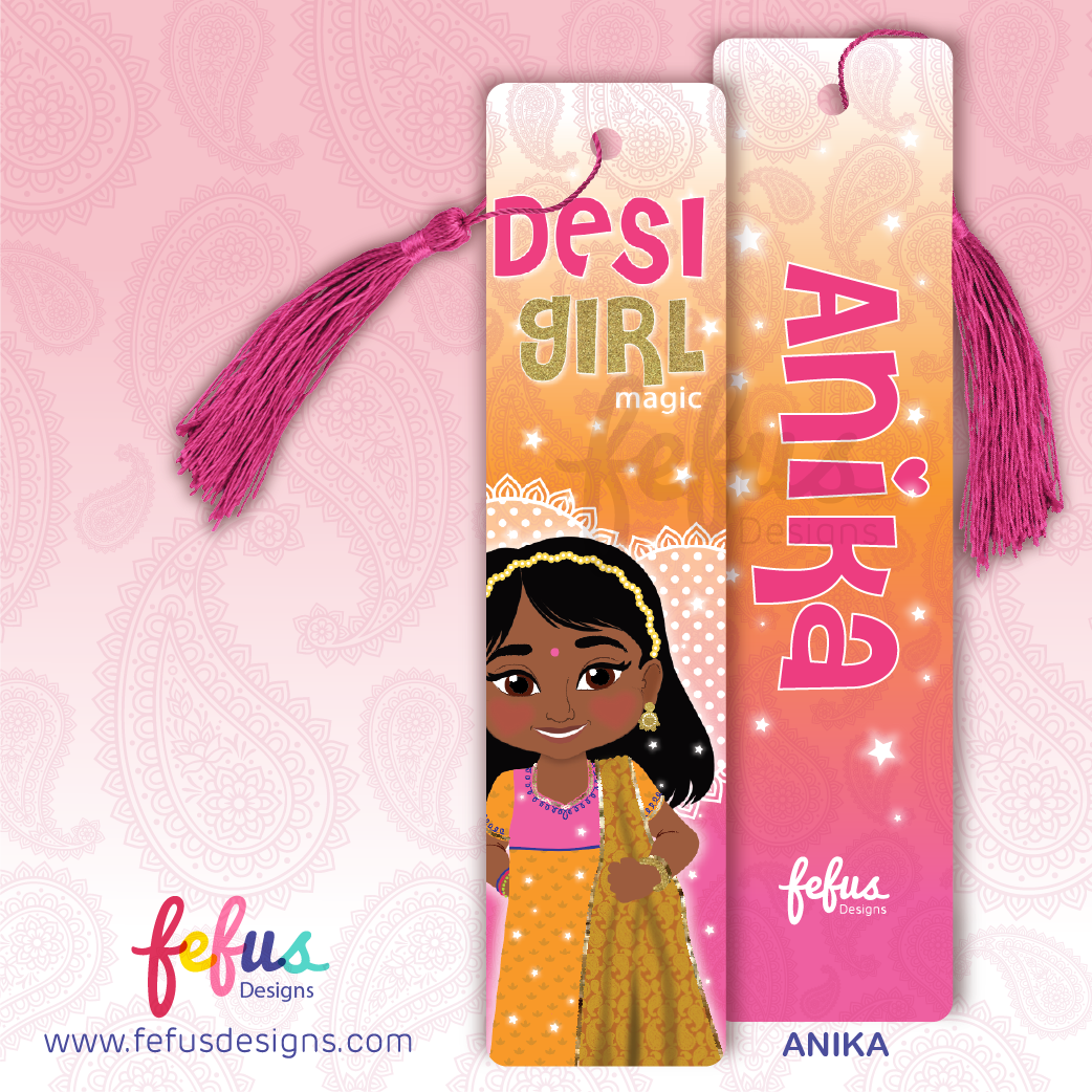 Front and back view of decorative bookmark cards with pink tassels on a pink patterned background. One card reads 'Desi Girl Magic' with an illustration of a girl in traditional Indian clothing, and the other reads 'Anika' with the Fefus Designs logo.