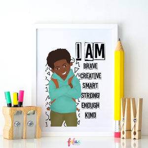 Jamal I Am Black Boy affirmation wall art for kids bedroom. An affirmation art print featuring a hand-drawn illustration of a young boy with the text 'I AM BRAVE, CREATIVE, SMART, STRONG, ENOUGH, KIND' displayed above. The print is framed with a white border, placed on a wooden easel with pencils and markers to the side.