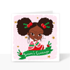 Front of the Black Girl Magic Christmas card featuring Deja with an Afro puff hairstyle, holly hair accessories and a Season's Greetings message.
