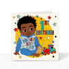 A vibrant and colourful square 1st birthday greeting card for boys, featuring an hand-drawn illustration of a joyful black boy smiling, with the text "1st Birthday" printed on a bright background. He's wearing a blue tracksuit, with the wording Brown Boy Joy on the front of the sweatshirt, he's surrounded by stars and a train by his feet.